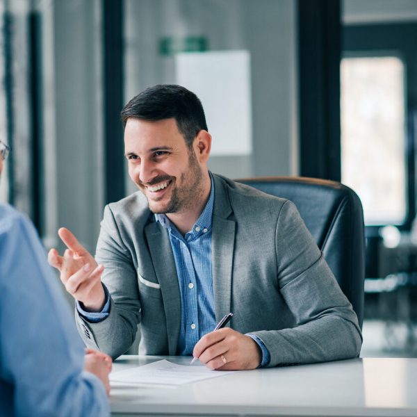 Man having a business meeting and signing a contract, recruitment or agreement.